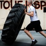 A Crossfit Gym Trainer Flipping Tyre